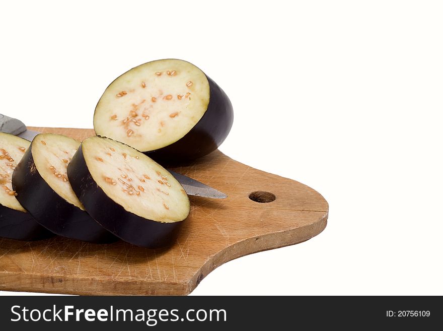 A partially sliced aubergine isolated in white background