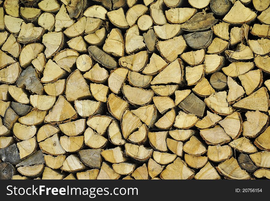Chopped firewood arranged in a big stack. Chopped firewood arranged in a big stack