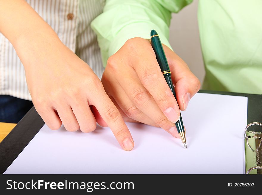 Two businesspeople signing a letter. Only hands in the picture