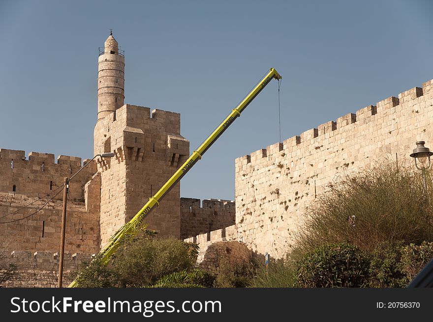 A construction crane reaches over the wall of Jerusalem's Old City near the Tower of David. A construction crane reaches over the wall of Jerusalem's Old City near the Tower of David