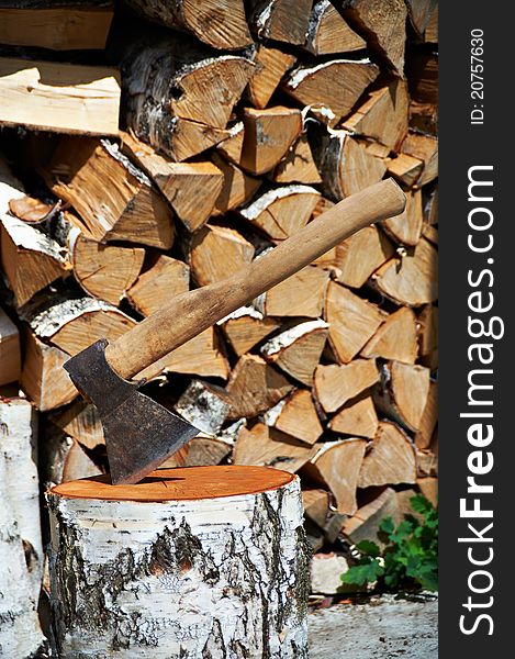 Wood axe and wood pile outdoor. Wood axe and wood pile outdoor