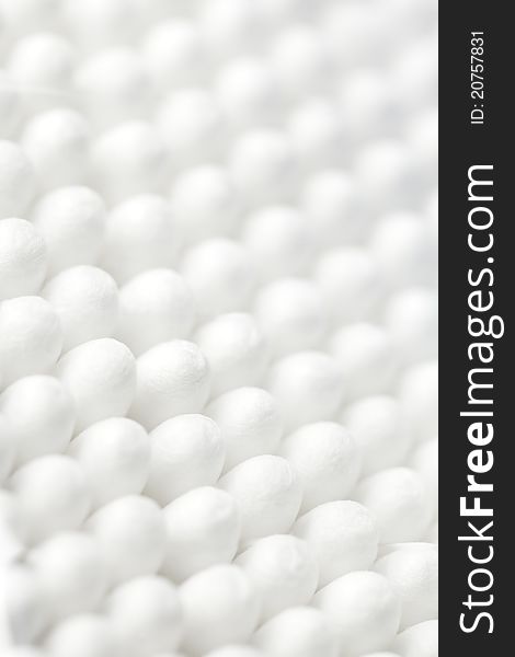 Cotton swabs background, vertical format, shallow dof.