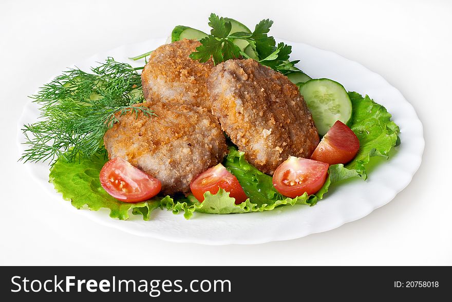 Meat rissoles with vegetables on white background