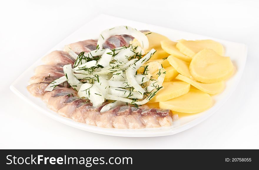 Salted herring slices with onion and boiled potato. Salted herring slices with onion and boiled potato