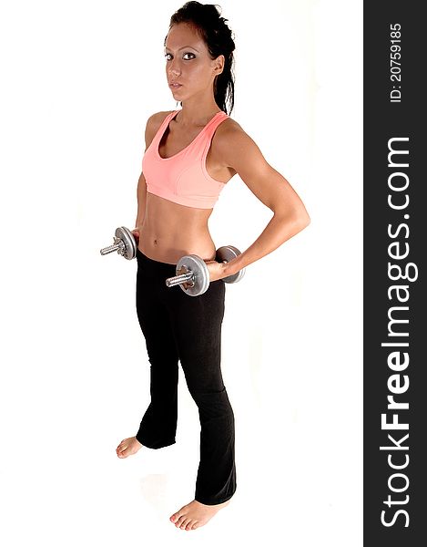 A pretty woman with dumbbells lifting, standing in the studio with bare feet, for white background. A pretty woman with dumbbells lifting, standing in the studio with bare feet, for white background.