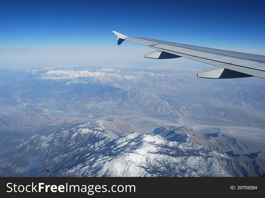 A plane wing overlooking the Rocky Mountains. A plane wing overlooking the Rocky Mountains.