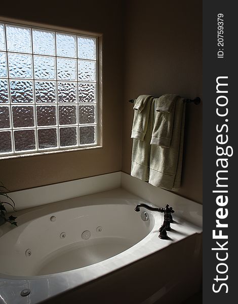 Private master bathtub with jacuzzi jets and glass block privacy window. Private master bathtub with jacuzzi jets and glass block privacy window.