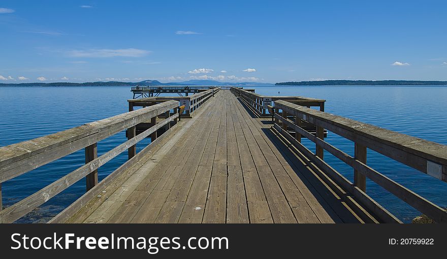 Wooden jetty over the beautiful pacific ocean with blue sky. Wooden jetty over the beautiful pacific ocean with blue sky