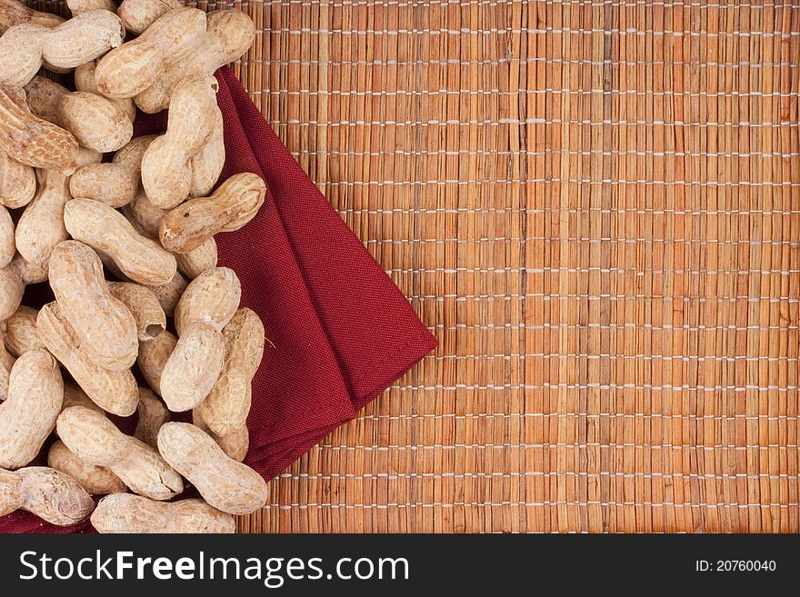 Nuts Peanuts on a mat with a red napkin.