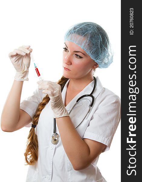 Beautiful nurse with long hair in a white robe holding a syringe with blood on an isolated white background. Beautiful nurse with long hair in a white robe holding a syringe with blood on an isolated white background