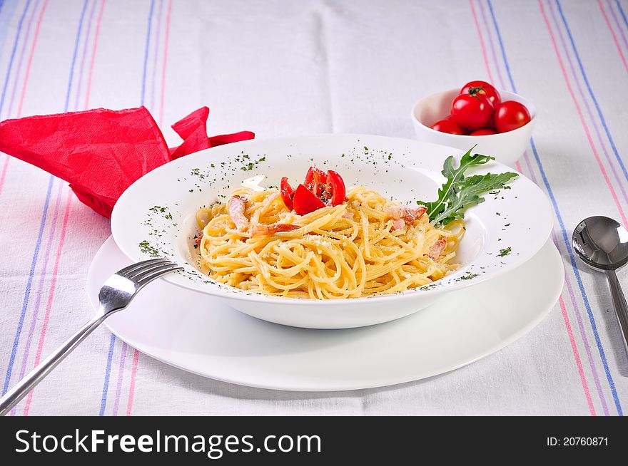 Italian spagetti with mozzarella and tomatoes on a plate