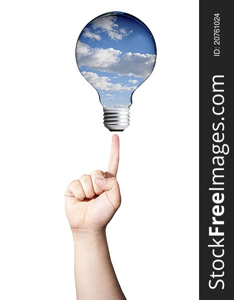 Green energy concept, Finger pointing to light bulb with sky inside. Green energy concept, Finger pointing to light bulb with sky inside