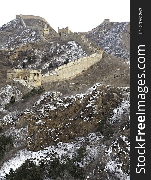 Distant view of the great wall of china with snow on the mountain. Distant view of the great wall of china with snow on the mountain