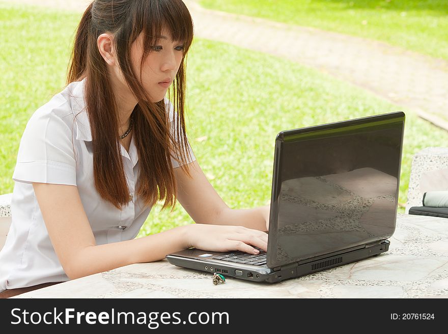 Asian young woman working with her notebook. Asian young woman working with her notebook