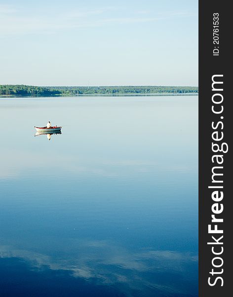 A rural blue lake and a green forest