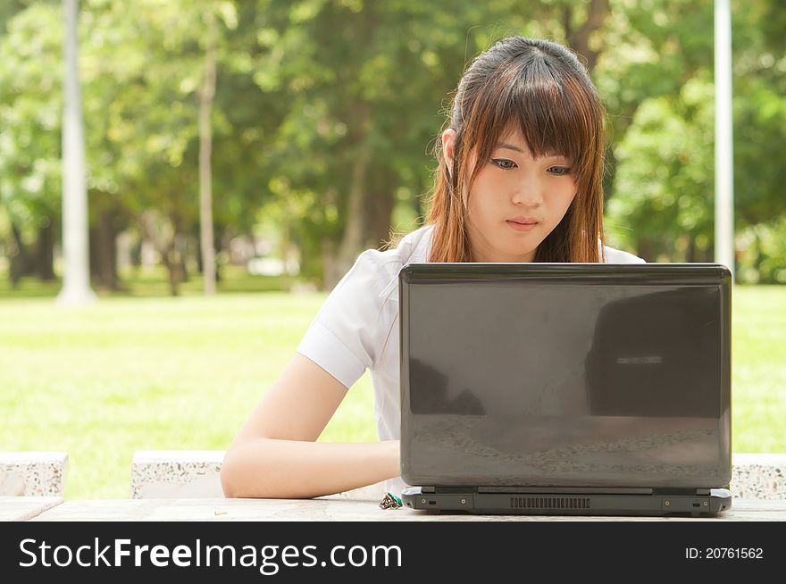 Young asian woman playing notebook. Young asian woman playing notebook