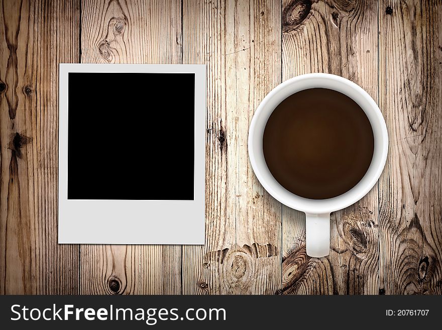 Blank photo and coffee on wooden background