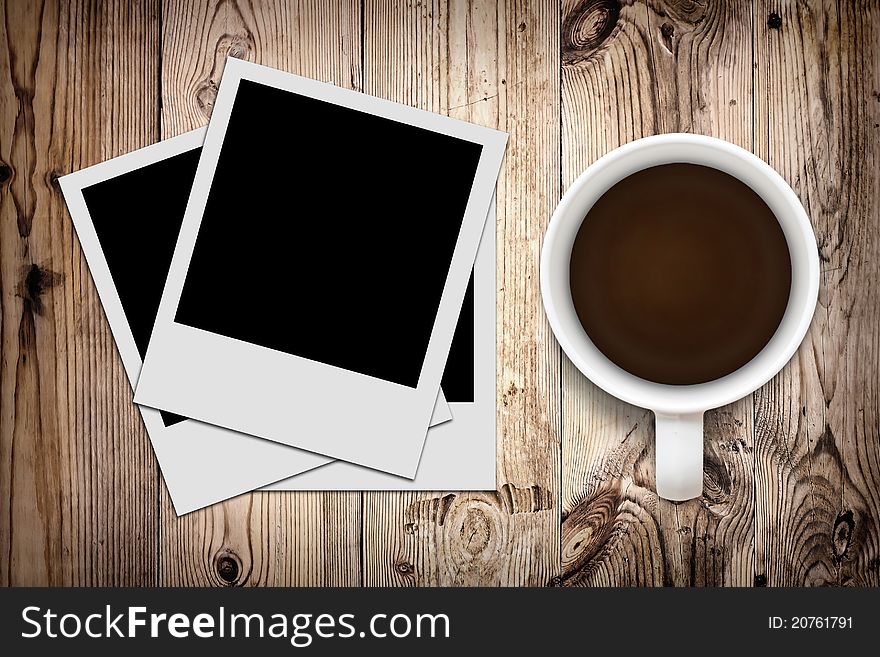Blank photo and coffee on wooden background