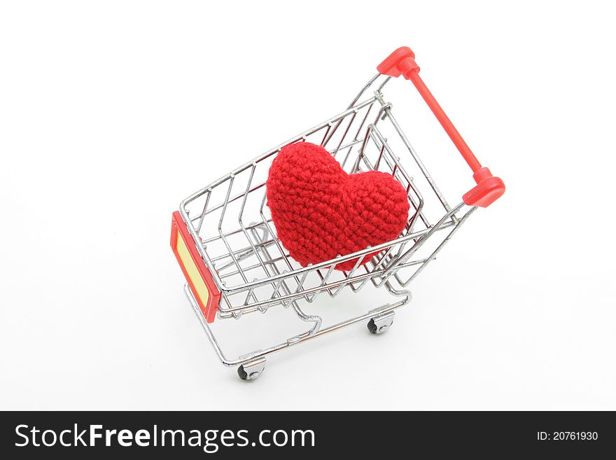 Love delivery concept, red heart in Shopping cart isolated on white