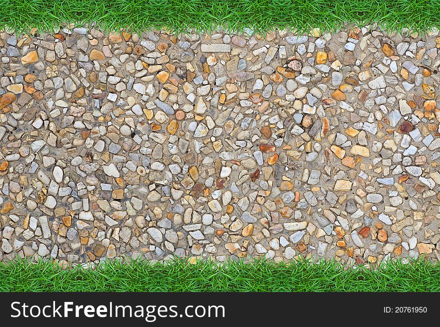 Black stone wall background with green grass