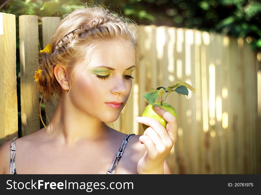 Young woman holding a green apple