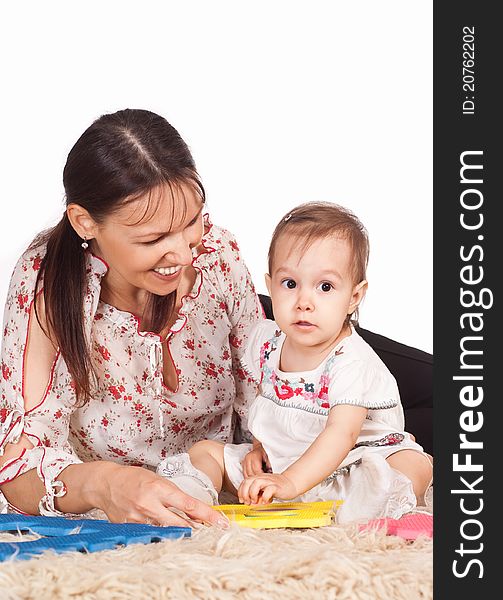 Mom with daughter on carpet on white