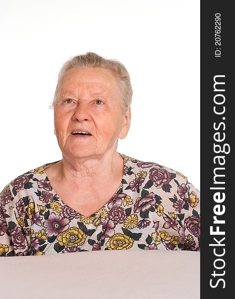 Cute granny posing at table on a white. Cute granny posing at table on a white