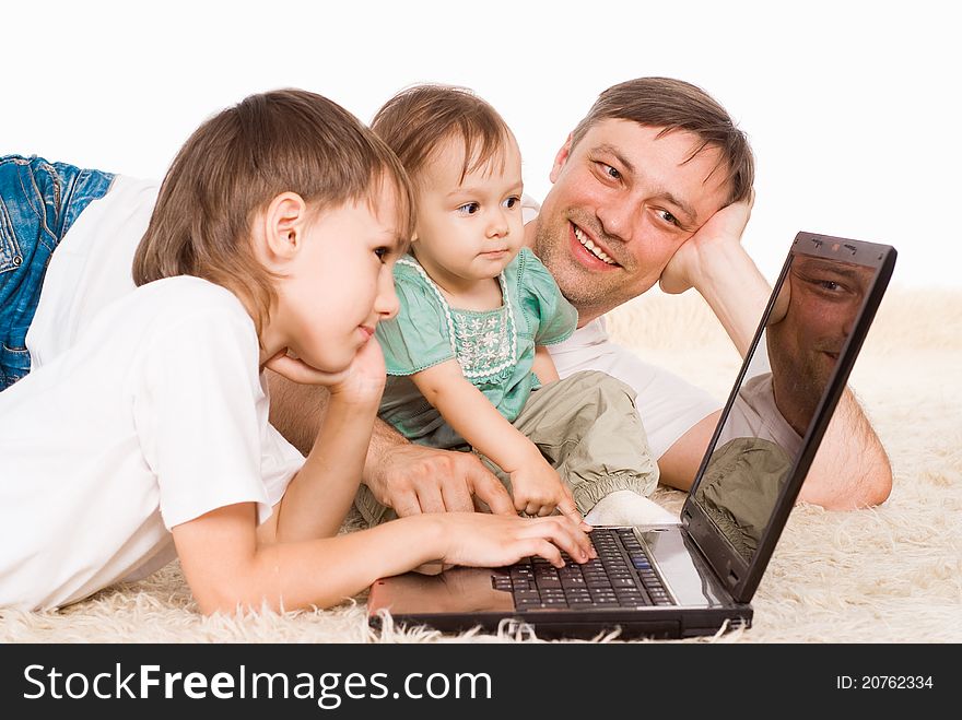 Cute dad and kids with a laptop. Cute dad and kids with a laptop