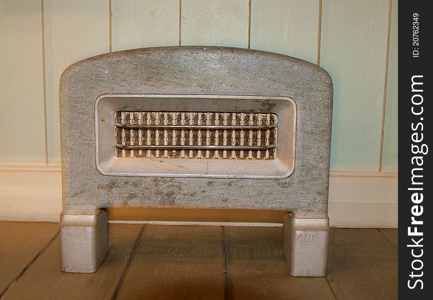 Old stone heater by a panel wall. Old stone heater by a panel wall