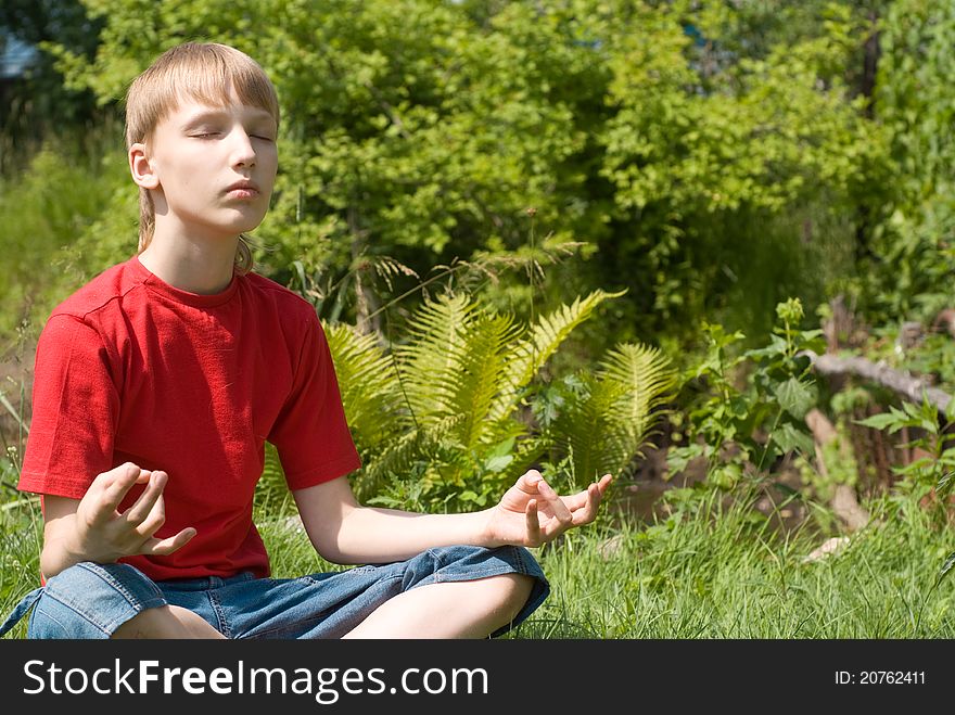 Cute young boy meditates at the nature. Cute young boy meditates at the nature