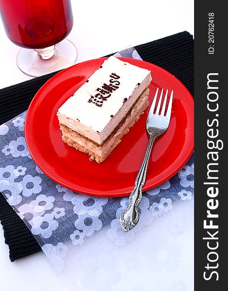 Tiramisu cake on red plate