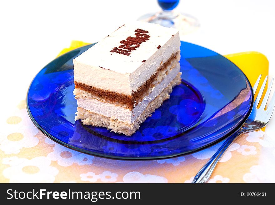 Tiramisu cake on blue plate