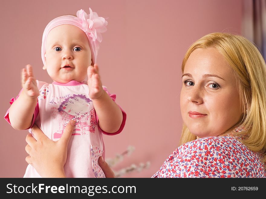 Cute mom with daughter on a pink. Cute mom with daughter on a pink