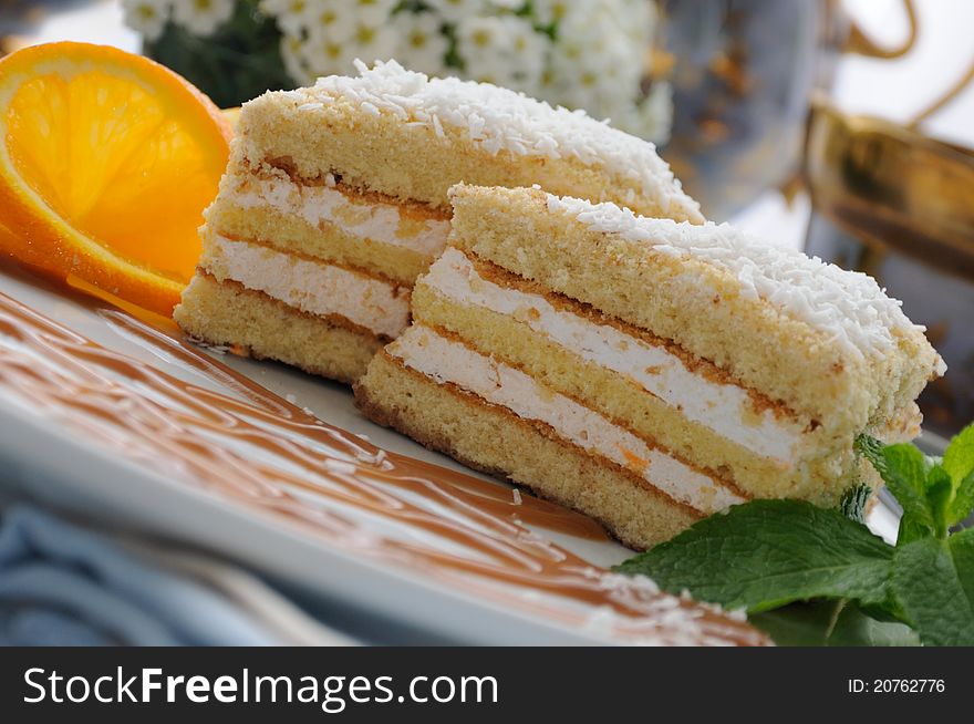 Sponge cake with a delicate souffle and a cup of tea. Sponge cake with a delicate souffle and a cup of tea