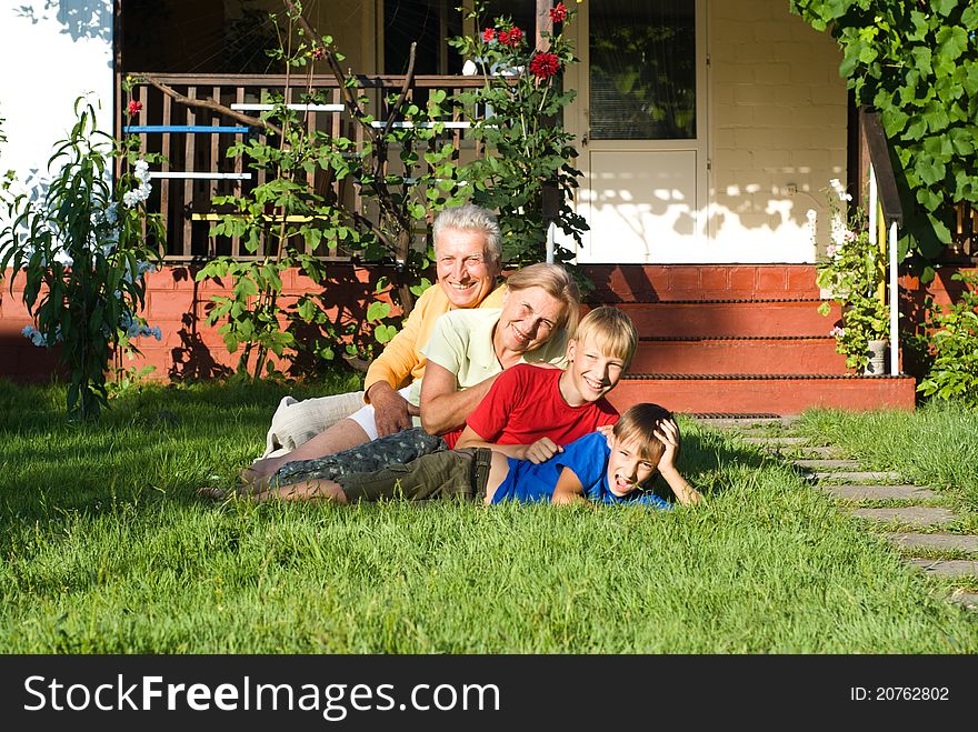 Boys with their grandparents play near the house. Boys with their grandparents play near the house