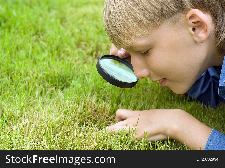Boy with a loupe at the nature. Boy with a loupe at the nature
