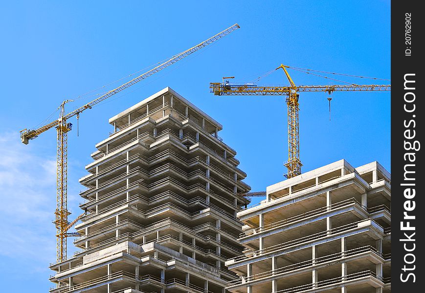 Two elevating cranes on a skyscraper building site. Two elevating cranes on a skyscraper building site