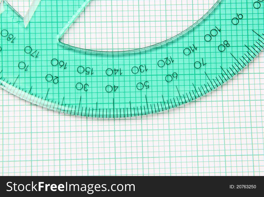 Translucent green protractor on green striped graph paper