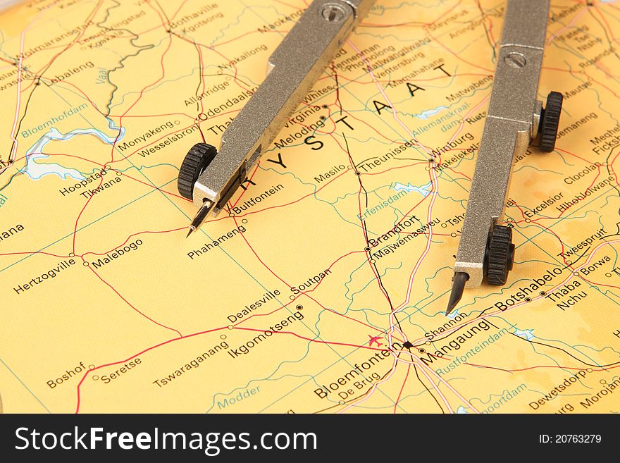 Mathematical compass lying on its side on a map. Mathematical compass lying on its side on a map