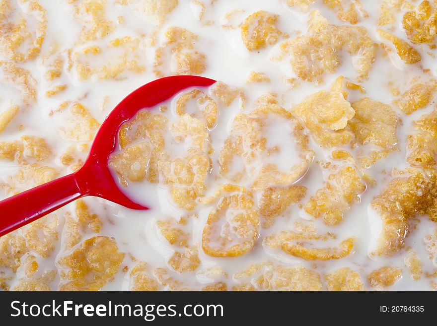 Cereal in the bowl with milk and red spoon, healthy breakfast food. Cereal in the bowl with milk and red spoon, healthy breakfast food