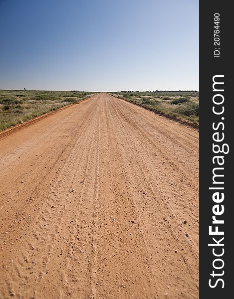 Unsealed country road in Australia stretching off to he horizon. Unsealed country road in Australia stretching off to he horizon