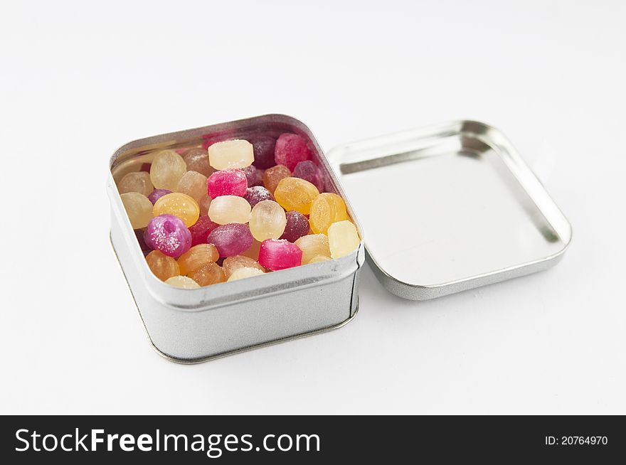 Colored candy in a box on a white background