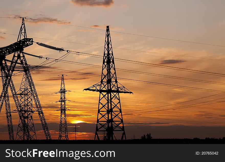 High voltage electricity pylon over sunset