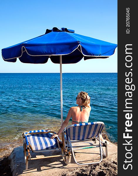 Young woman relaxing on the beach.Rear view. Young woman relaxing on the beach.Rear view