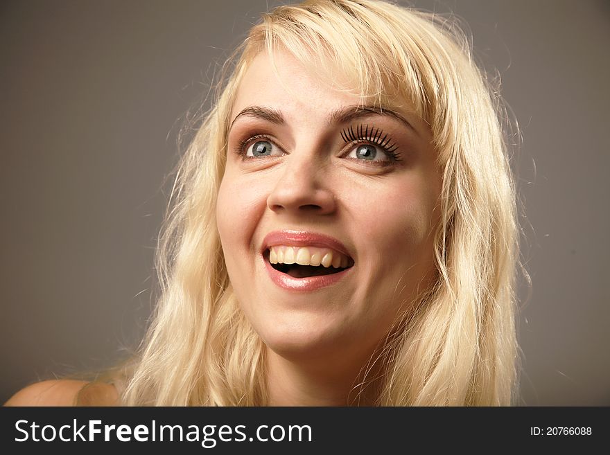 Close-up of a young woman looking very surprised