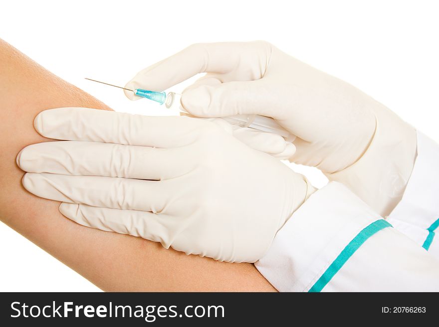 Syringe and a hand on a white background.