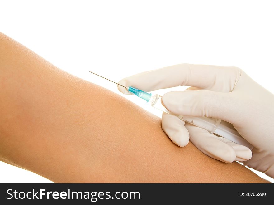 Syringe and a hand on a white background.