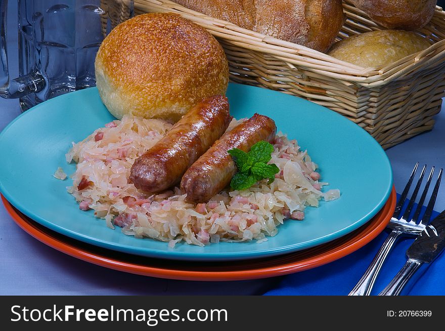 Sausages with sauerkraut and fresh rolls. Sausages with sauerkraut and fresh rolls