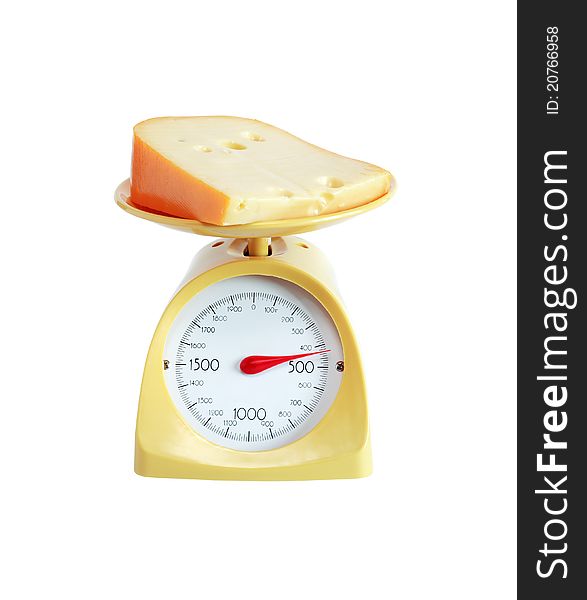 Piece of cheese lying on nice yellow kitchen scale. Isolated on white with clipping path. Piece of cheese lying on nice yellow kitchen scale. Isolated on white with clipping path