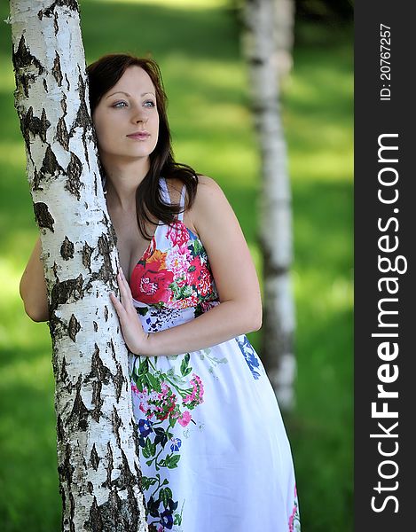 Beautiful future mom standing near tree. summer's day. Beautiful future mom standing near tree. summer's day.